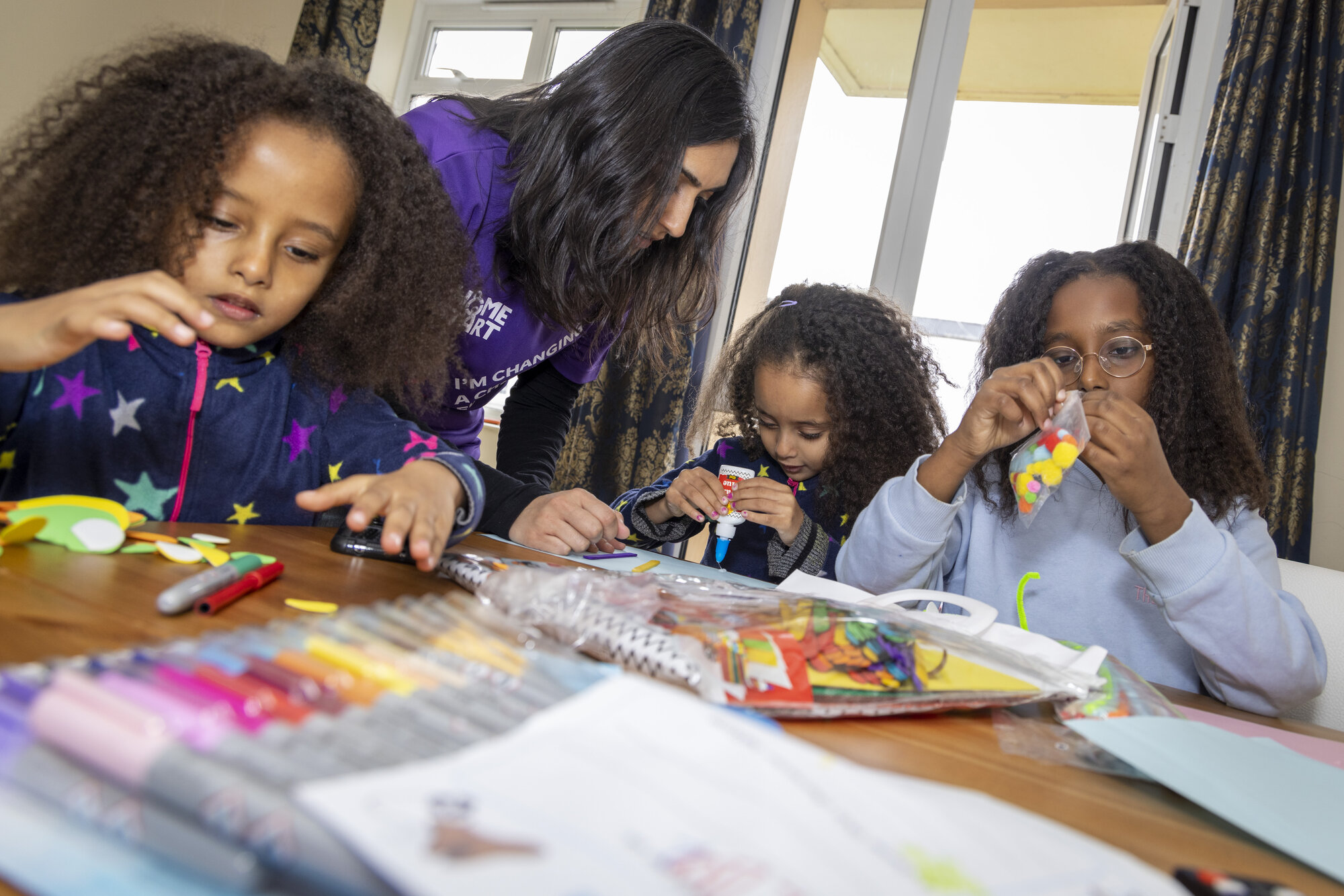 A volunteer crafting with children